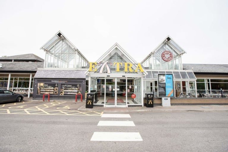 Modern motorway service area with a convenience store and dining options.
